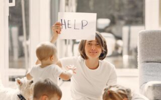 tired mother asking for help while sitting with children