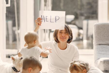 tired mother asking for help while sitting with children