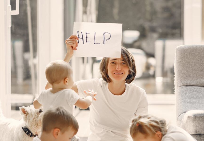 tired mother asking for help while sitting with children